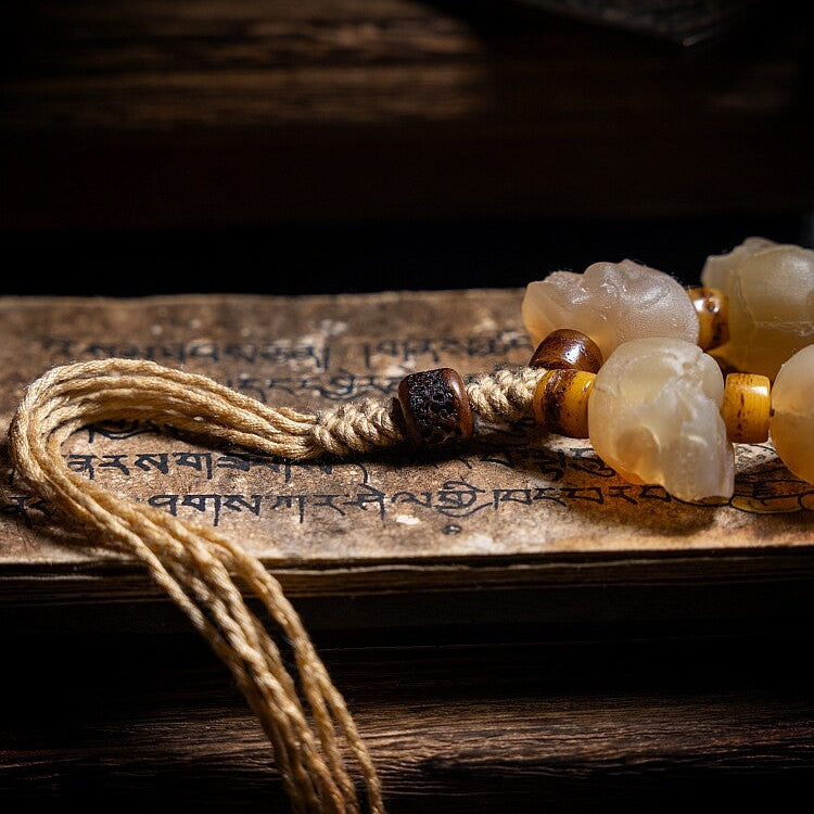 Beaded bracelet with natural stones on an ancient text background