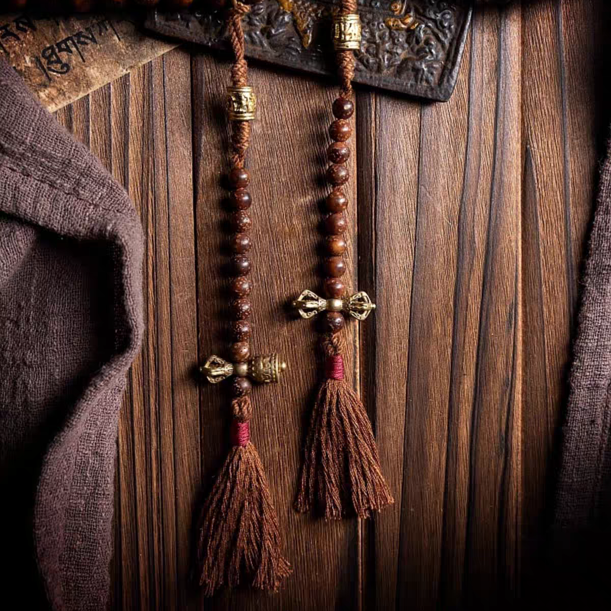 Wooden rosary with tassels on a wooden background
