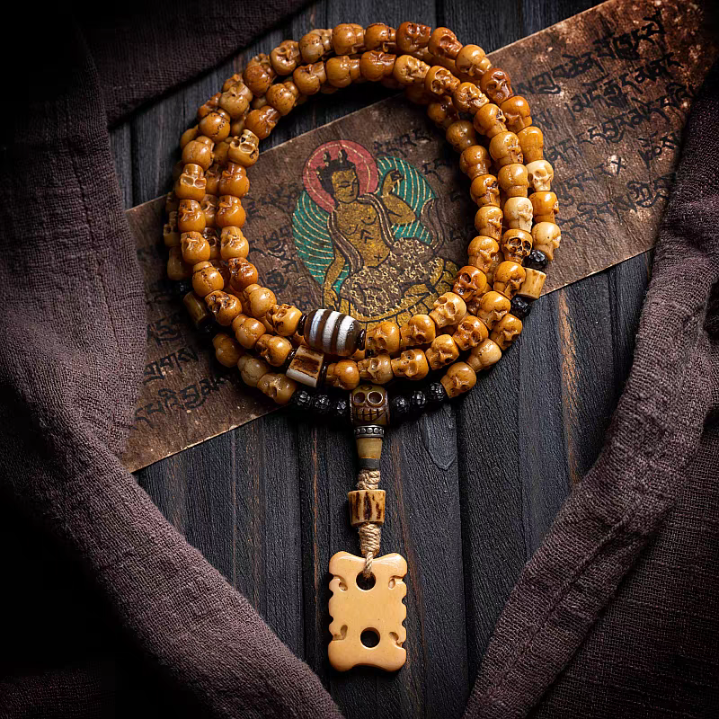 Beaded necklace with a decorative pendant on a textured wooden background
