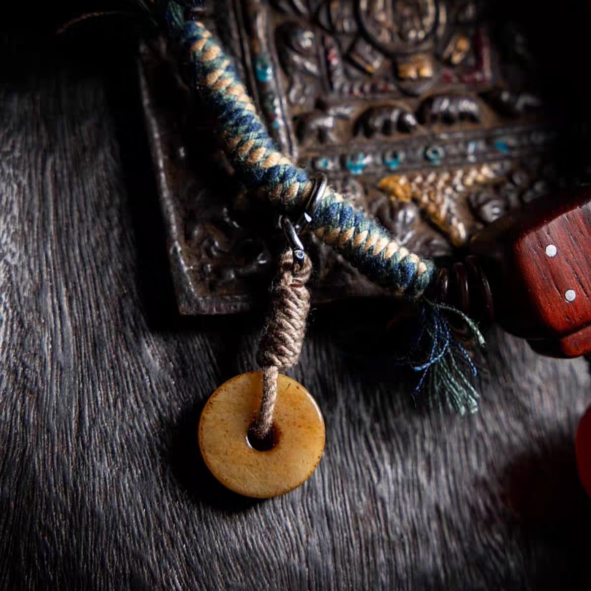 Bracelet with braided design and yak bone bead on a textured surface